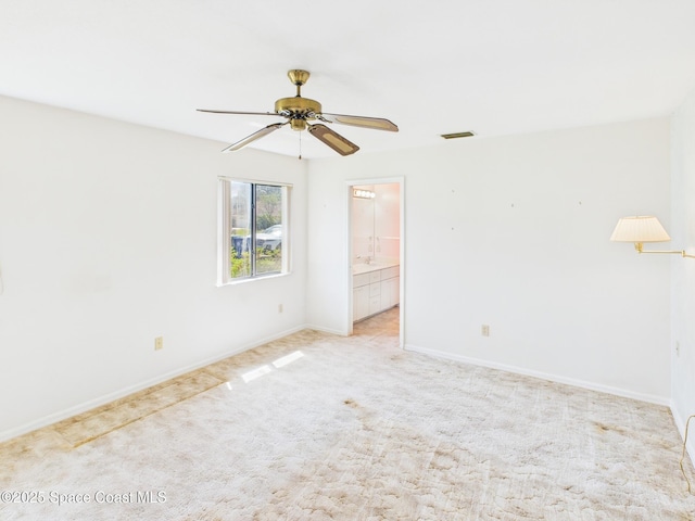 unfurnished room with light carpet, baseboards, a ceiling fan, and visible vents