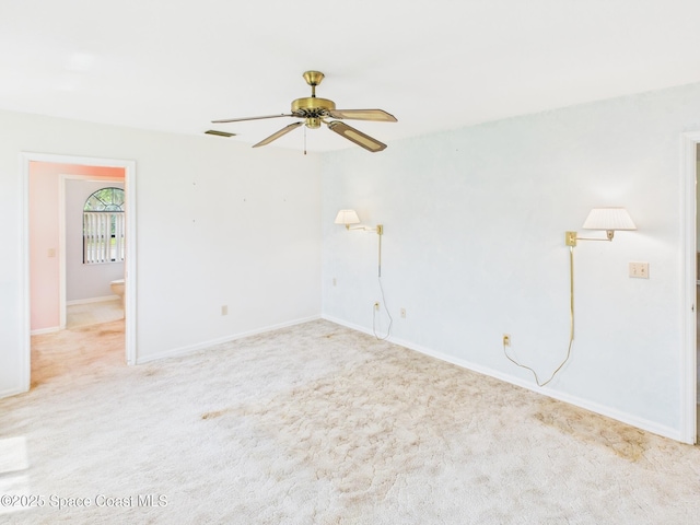 carpeted empty room with ceiling fan, baseboards, and visible vents
