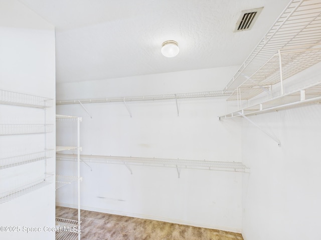 walk in closet with visible vents