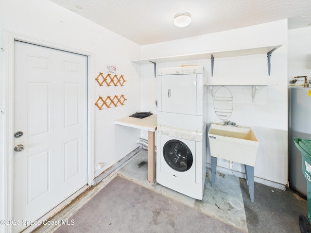 laundry area with stacked washing maching and dryer and a sink