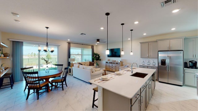 kitchen featuring a sink, stainless steel fridge with ice dispenser, gray cabinets, visible vents, and marble finish floor