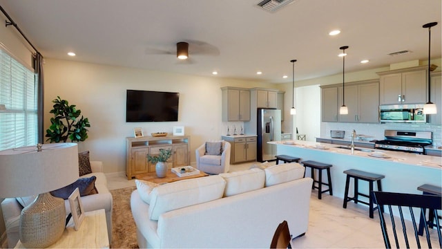 living area featuring marble finish floor, a ceiling fan, visible vents, and recessed lighting