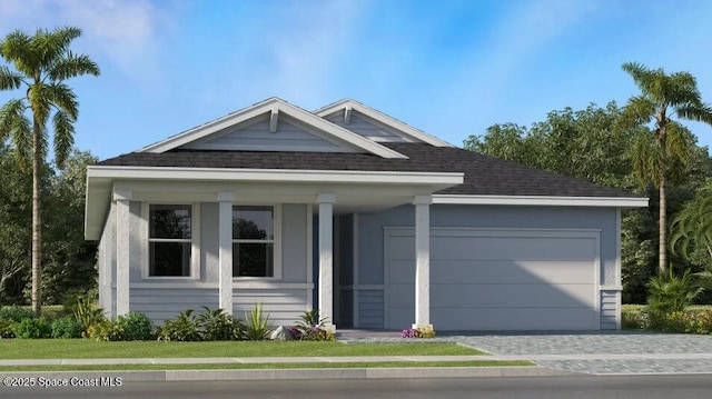 single story home featuring a porch, roof with shingles, a garage, and decorative driveway