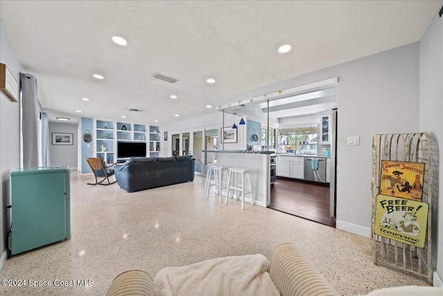 living area featuring speckled floor, baseboards, french doors, and recessed lighting