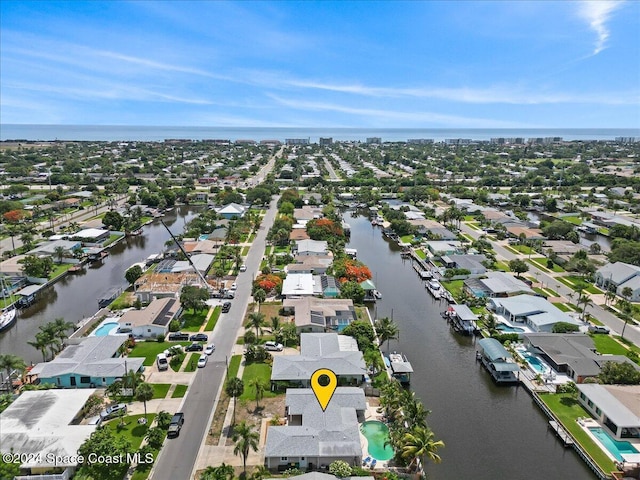 birds eye view of property with a water view and a residential view