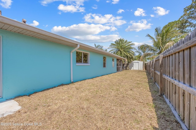 619 Dinner St NE, Palm Bay, FL 32907 - view of yard with a fenced backyard, an outdoor structure, and a shed