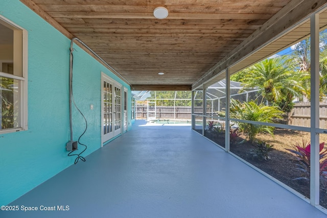619 Dinner St NE, Palm Bay, FL 32907 - view of patio featuring glass enclosure, french doors, and a fenced backyard