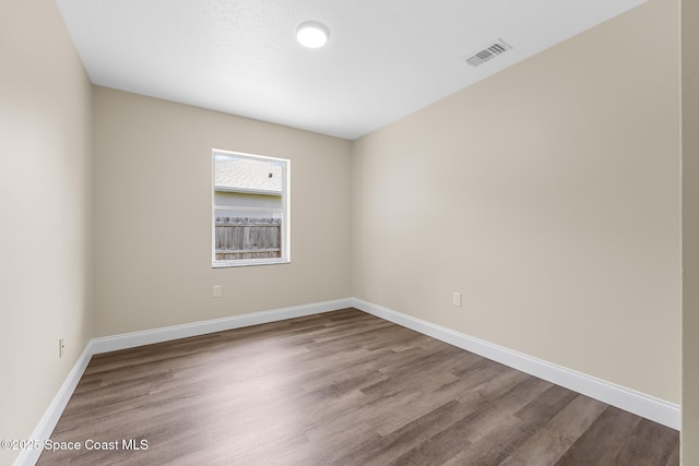 619 Dinner St NE, Palm Bay, FL 32907 - empty room with baseboards, visible vents, and wood finished floors