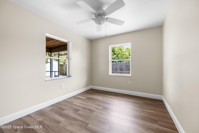 619 Dinner St NE, Palm Bay, FL 32907 - spare room featuring baseboards, a ceiling fan, and wood finished floors