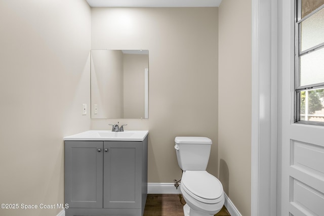 619 Dinner St NE, Palm Bay, FL 32907 - bathroom featuring toilet, baseboards, vanity, and wood finished floors
