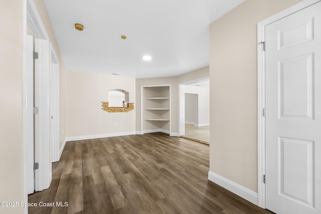 619 Dinner St NE, Palm Bay, FL 32907 - interior space featuring dark wood finished floors, built in shelves, and baseboards