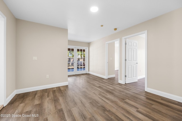 619 Dinner St NE, Palm Bay, FL 32907 - unfurnished room with baseboards, french doors, and wood finished floors