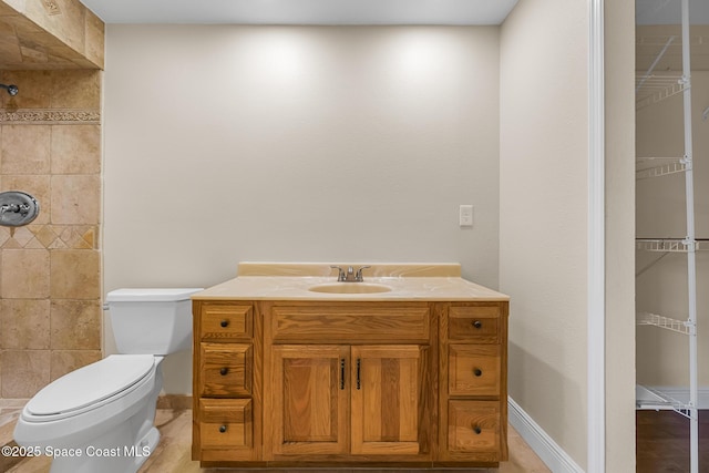 619 Dinner St NE, Palm Bay, FL 32907 - full bathroom with toilet, tiled shower, vanity, and baseboards