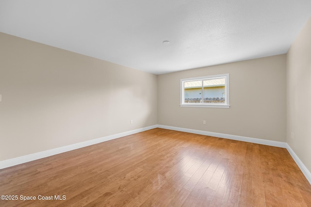 619 Dinner St NE, Palm Bay, FL 32907 - spare room with baseboards and light wood-style floors