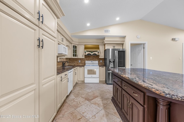 619 Dinner St NE, Palm Bay, FL 32907 - kitchen featuring dark stone countertops, visible vents, white appliances, tasteful backsplash, and lofted ceiling