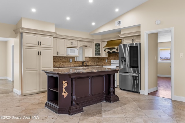 619 Dinner St NE, Palm Bay, FL 32907 - kitchen with dark stone countertops, open shelves, white appliances, backsplash, and lofted ceiling