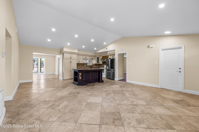 619 Dinner St NE, Palm Bay, FL 32907 - kitchen with lofted ceiling, open floor plan, stainless steel refrigerator with ice dispenser, dark countertops, and tasteful backsplash