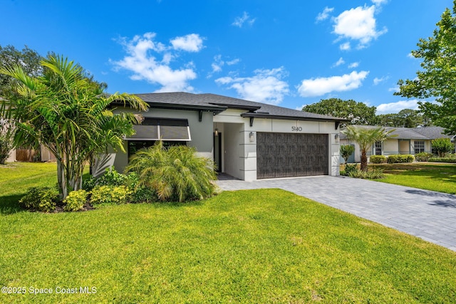 prairie-style house with an attached garage, stucco siding, decorative driveway, and a front yard