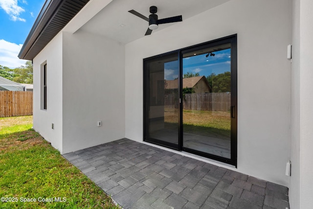 view of patio featuring fence and a ceiling fan