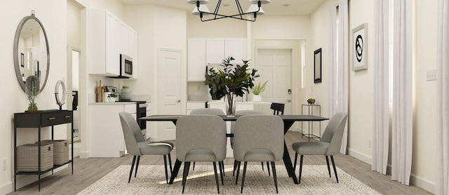 dining area featuring baseboards, a notable chandelier, and light wood-style flooring