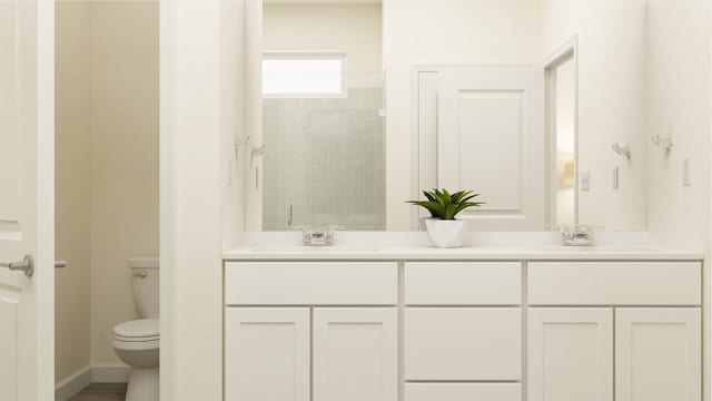 bathroom featuring double vanity, toilet, tiled shower, and a sink