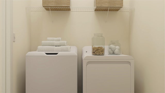 clothes washing area featuring laundry area and separate washer and dryer