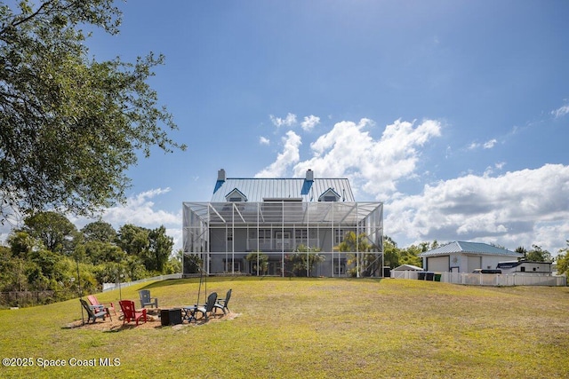 3824 Luxury Ln, Titusville, FL 32796 - view of green lawn featuring a fire pit and glass enclosure