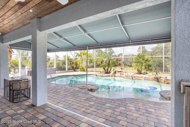 3824 Luxury Ln, Titusville, FL 32796 - outdoor pool featuring a patio and glass enclosure