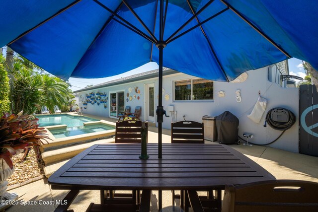 190 Harwood Ave, Satellite Beach, FL 32937 - view of patio / terrace with outdoor dining space and a pool with connected hot tub