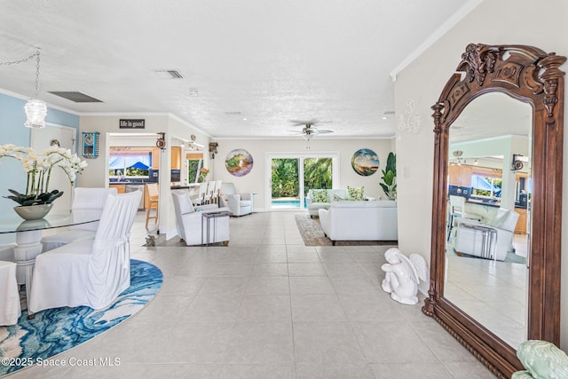 190 Harwood Ave, Satellite Beach, FL 32937 - dining area featuring ornamental molding, tile patterned flooring, ceiling fan, a textured ceiling, and a chandelier