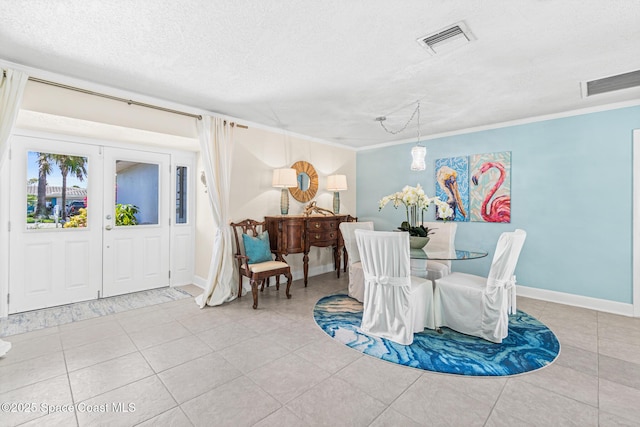 190 Harwood Ave, Satellite Beach, FL 32937 - dining space featuring tile patterned floors, ornamental molding, baseboards, and a textured ceiling