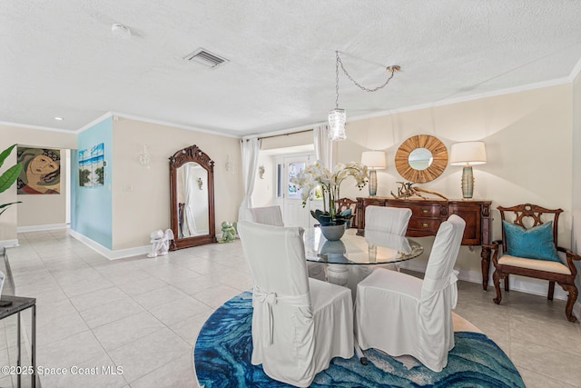 190 Harwood Ave, Satellite Beach, FL 32937 - dining space featuring light tile patterned floors, ornamental molding, a textured ceiling, and baseboards