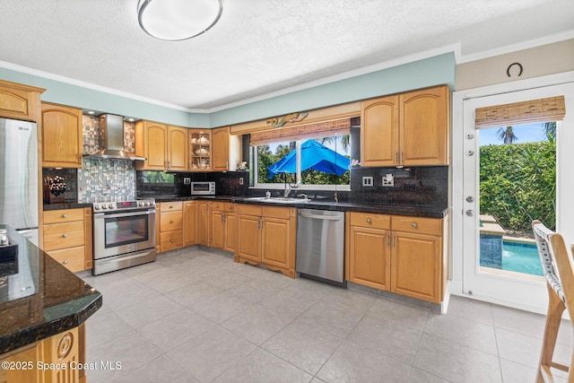 190 Harwood Ave, Satellite Beach, FL 32937 - kitchen featuring stainless steel appliances, wall chimney range hood, a sink, backsplash, and ornamental molding