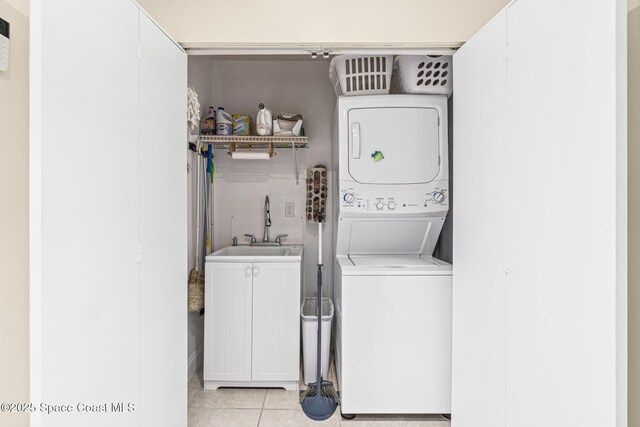 190 Harwood Ave, Satellite Beach, FL 32937 - laundry room featuring stacked washer / drying machine, cabinet space, and light tile patterned floors