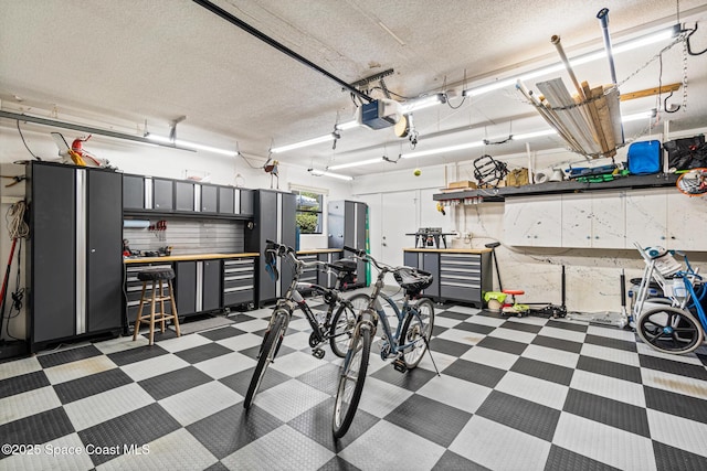 190 Harwood Ave, Satellite Beach, FL 32937 - garage featuring a garage door opener and a workshop area