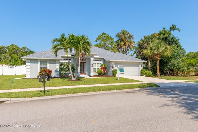 4569 Lady Hawk Way, Melbourne, FL 32904 - view of front of house with a garage, driveway, and stucco siding