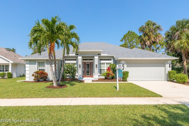 4569 Lady Hawk Way, Melbourne, FL 32904 - view of front of house featuring a garage, a front lawn, concrete driveway, and stucco siding