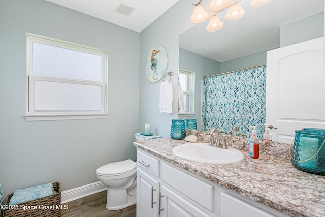 4569 Lady Hawk Way, Melbourne, FL 32904 - full bath featuring wood finished floors, toilet, vanity, baseboards, and a chandelier