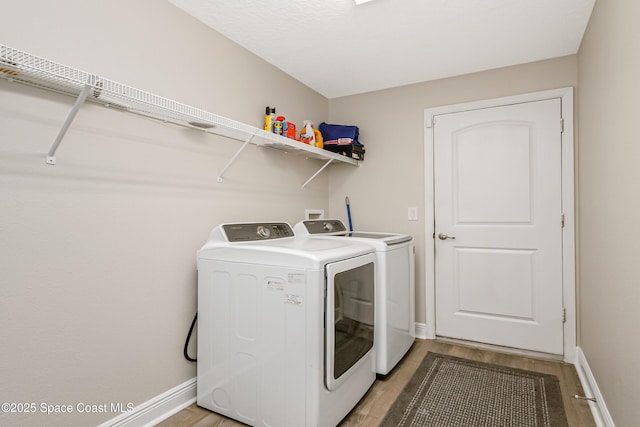 4569 Lady Hawk Way, Melbourne, FL 32904 - clothes washing area with washing machine and clothes dryer, light wood-style floors, and baseboards