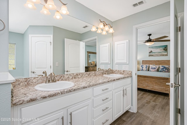 4569 Lady Hawk Way, Melbourne, FL 32904 - ensuite bathroom with wood finished floors, double vanity, and a ceiling fan