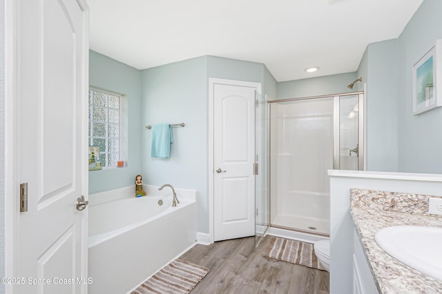 4569 Lady Hawk Way, Melbourne, FL 32904 - bathroom with wood finished floors, a shower stall, toilet, and a bath
