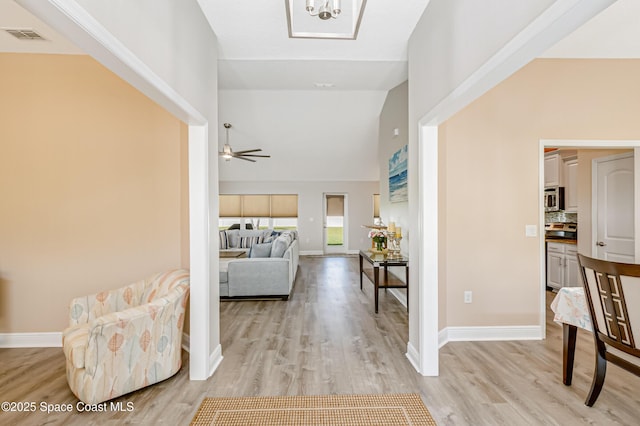 4569 Lady Hawk Way, Melbourne, FL 32904 - corridor with light wood-style flooring, baseboards, and high vaulted ceiling