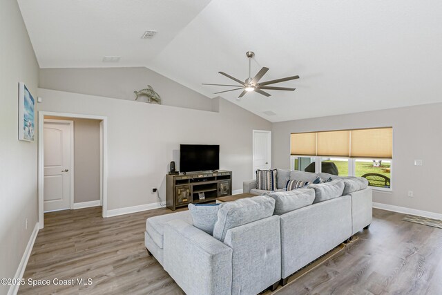 4569 Lady Hawk Way, Melbourne, FL 32904 - living area featuring a ceiling fan, wood finished floors, high vaulted ceiling, and baseboards