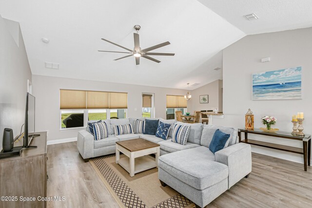 4569 Lady Hawk Way, Melbourne, FL 32904 - living room with vaulted ceiling, light wood-style floors, a ceiling fan, and baseboards