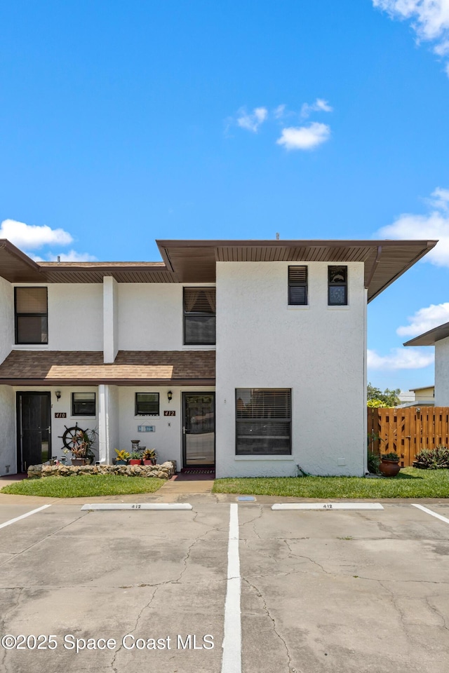 412 Sailfish Ave Unit 16, Cape Canaveral, FL 32920 - view of property with fence and uncovered parking