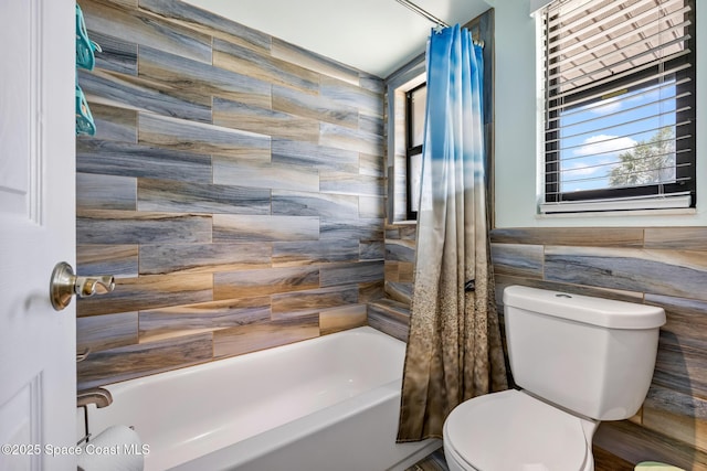 412 Sailfish Ave Unit 16, Cape Canaveral, FL 32920 - bathroom featuring tile walls, toilet, and shower / tub combo