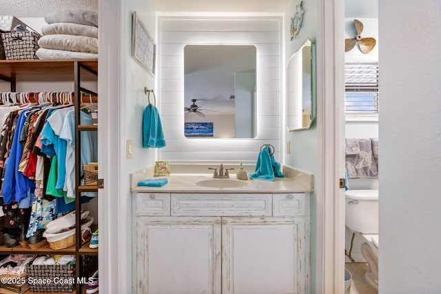 412 Sailfish Ave Unit 16, Cape Canaveral, FL 32920 - bathroom with vanity, ceiling fan, toilet, and a walk in closet