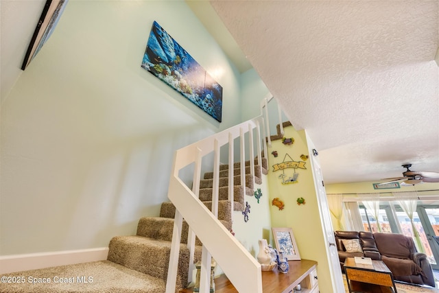 412 Sailfish Ave Unit 16, Cape Canaveral, FL 32920 - stairs featuring a textured ceiling, a ceiling fan, carpet floors, and baseboards