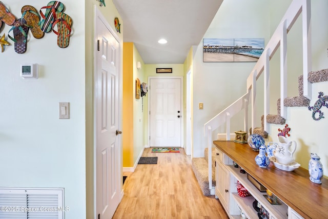 412 Sailfish Ave Unit 16, Cape Canaveral, FL 32920 - hallway with light wood finished floors, stairway, baseboards, and recessed lighting