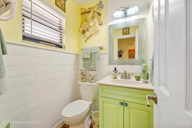 412 Sailfish Ave Unit 16, Cape Canaveral, FL 32920 - bathroom with toilet, vanity, and wainscoting